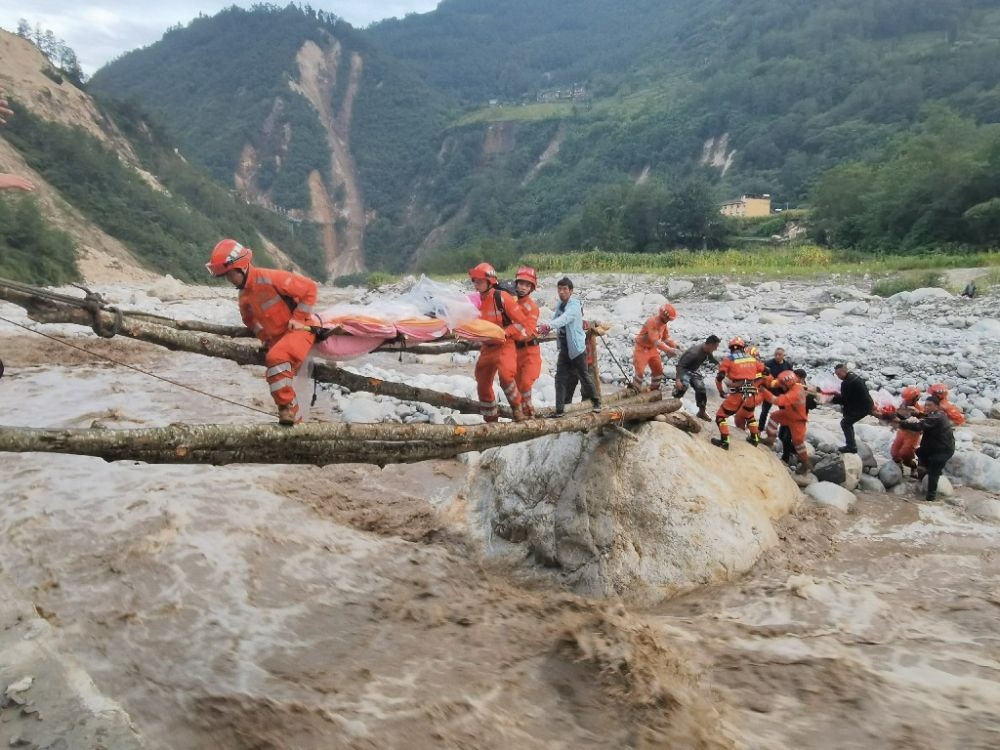 ↑2022年9月5日，武警四川總隊(duì)機(jī)動(dòng)第二支隊(duì)官兵在甘孜州瀘定縣磨西鎮(zhèn)磨子溝村搭建臨時(shí)木橋轉(zhuǎn)移被困群眾（手機(jī)照片）。新華社發(fā)（洪福樂 攝）