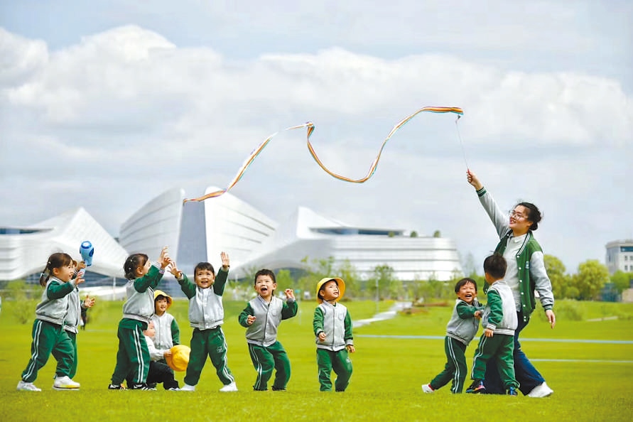  童心飛揚(yáng) 在浙江衢州市智慧新城草坪公園，一名幼兒園老師揮舞彩帶，與孩子們一起玩耍。衢州市柯城區(qū)將兒童友好理念融入城區(qū)整體規(guī)劃，努力為兒童成長(zhǎng)創(chuàng)造更好的發(fā)展環(huán)境，提升兒童和家庭的獲得感、幸福感、安全感。 衢州市柯城區(qū)某幼兒園哥倫比亞籍教師 莉莉安娜·雷斯特雷波·埃斯皮諾薩攝 “我和家人都很喜歡在衢州生活，這是一座兒童友好城市，有很多兒童營(yíng)地和戶(hù)外活動(dòng)場(chǎng)所。我看到孩子們?cè)谟變簣@、戶(hù)外非?？鞓?lè)地玩耍，便用相機(jī)記錄下這美好時(shí)刻。”