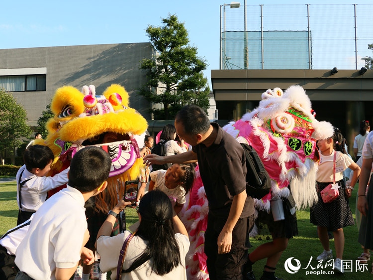 孩子們好奇地圍觀舞獅。人民網(wǎng) 許可攝